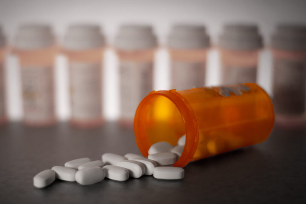 Pills spilling out of a prescription medication container