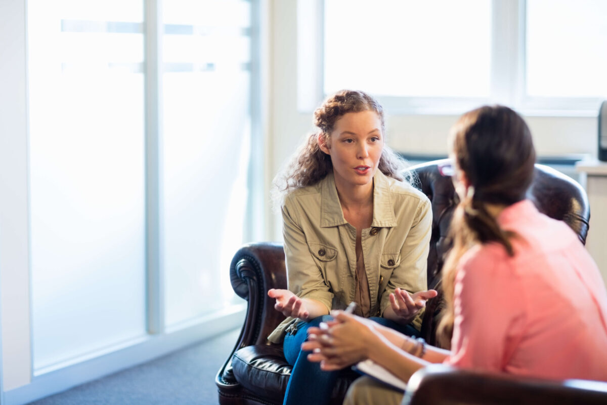 A woman talks to a therapist