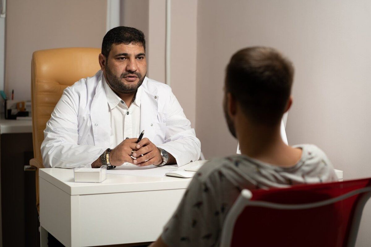 A doctor sits across from a patient
