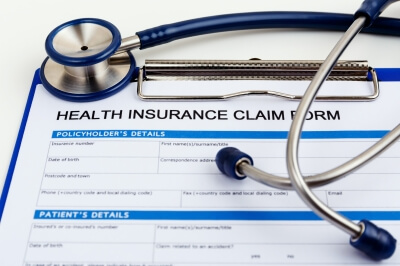 Health insurance claim form with stethoscope on top of it